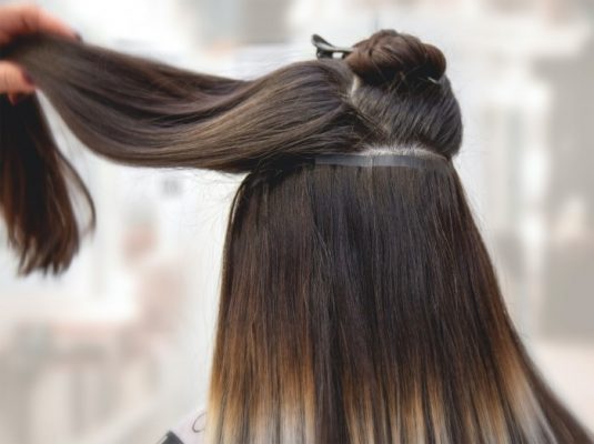 Extensions using human hair tape